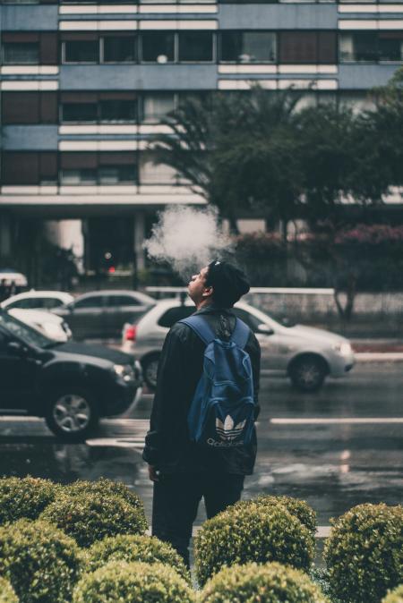 Man Wearing Black Jacket And Blue Adidas Backpack