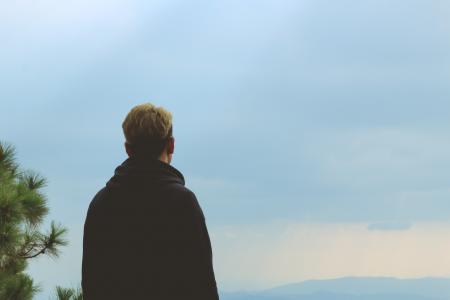 Man Wearing Black Jacket Standing Near Tree