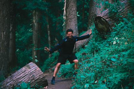 Man Wearing Black Jacket Standing on Forest