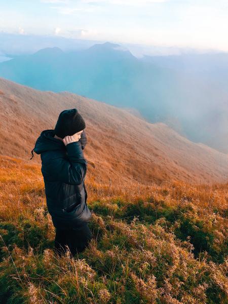 Man Wearing Black Jacket Standing On Grass Field