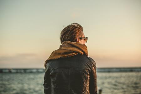 Man Wearing Black Leather Jacket during Sunset