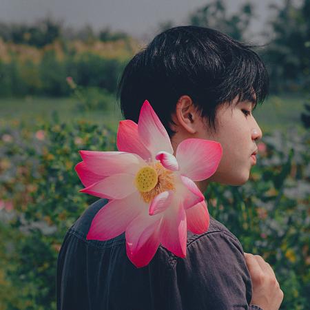 Man Wearing Black Top Holding Pink-and-white Petaled Flower