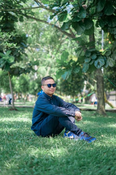 Man Wearing Blue Dress Shirts Seating on Grass