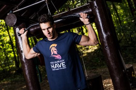 Man Wearing Blue Shirt Using Gym Equipments