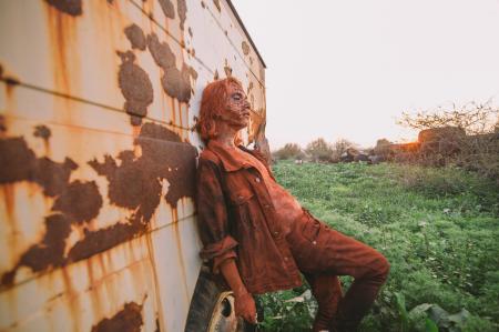Man Wearing Brown Button-up Jacket and Pants Leaning on Wall