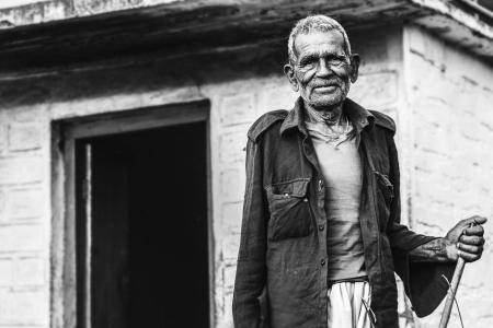 Man Wearing Button-up Shirt Standing Near Concrete House Greyscale Photo