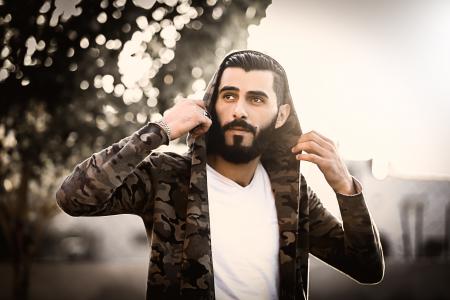 Man Wearing Camouflage Hoodie and White Shirt