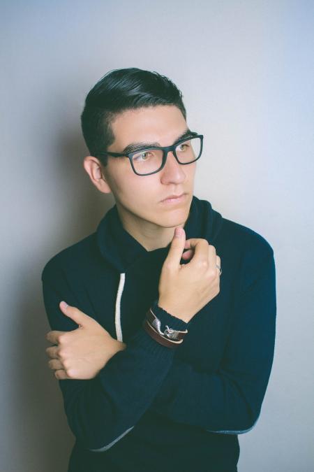 Man Wearing Eyeglasses Standing Near the Wall