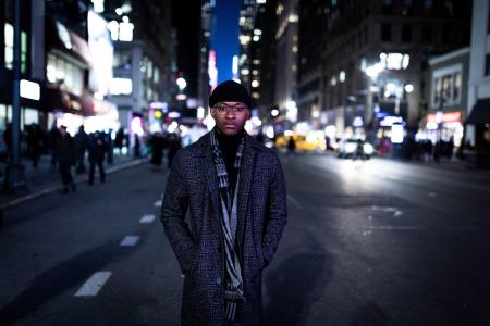 Man Wearing Gray Coat Standing in the Middle of the Road