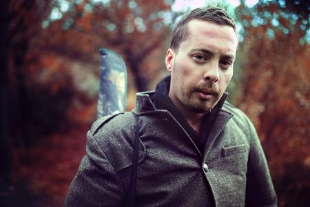 Man Wearing Gray Jacket in Front of Trees