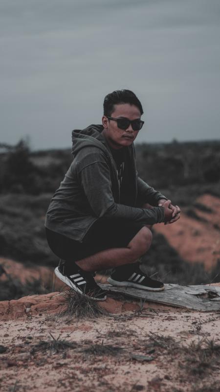 Man Wearing Hoodie Near Cliff