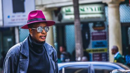 Man Wearing Purple Hat and Black Leather Jacket