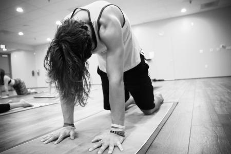 Man Wearing Tank Top and Short Lapping on Yoga Mat Inside Studio