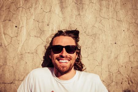 Man Wearing White Crew-neck Shirt Beside Wall