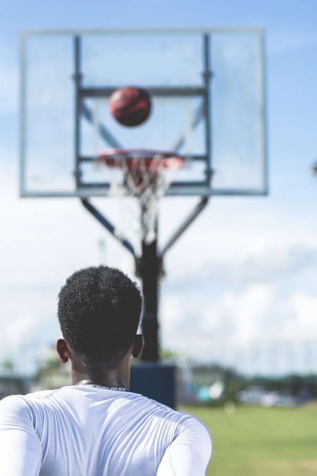 Man Wearing White Long-sleeved Shirt Near Basketball Hoop