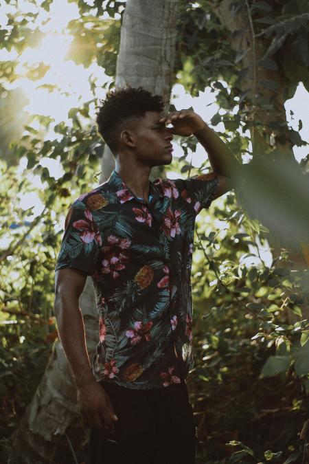 Man Wears Multicolored Floral Button-up Short-sleeved Shirt Beside Tree