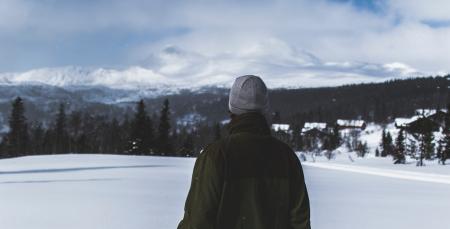 Man With Black Jacket and Grey Knit Cap Standing on White Snow Field