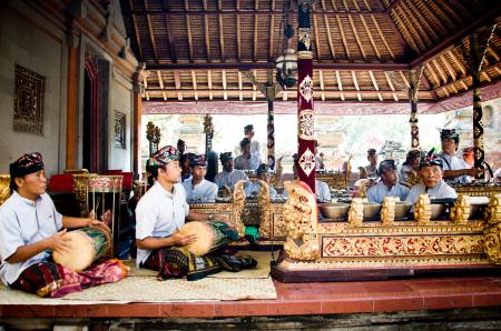 Men play traditional gamelan percussion