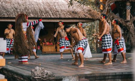 Men Wearing White and Black Checked Sarong Standing on Stage