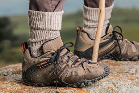 Men's Brown and Gray Merrell Hiking Shoes Holding Stick