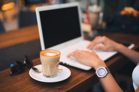 Midsection of Man Using Mobile Phone While Sitting on Table