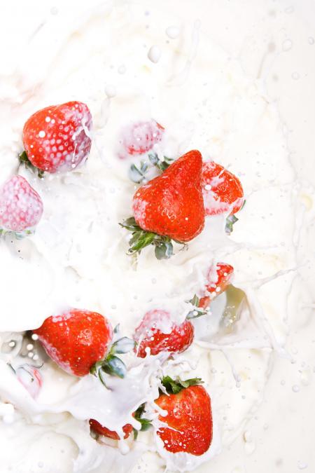 Milk and strawberries splashing