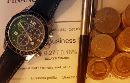 Money - Euros and British Pounds - Financial Markets Concept with Watc