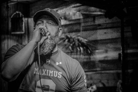 Monochrome Photography of Man Holding Microphone