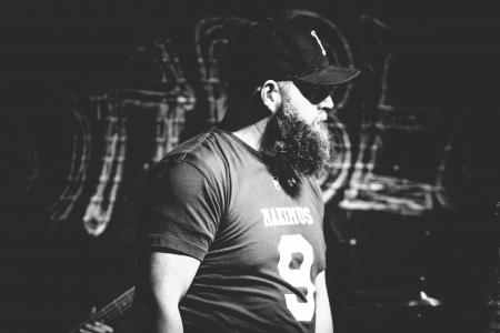 Monochrome Photography of Man Wearing Black Cap