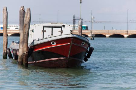 Moored boat with train in background
