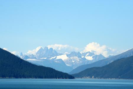 Mountain With Snow Cap Under Cloudy Sky at Daytime