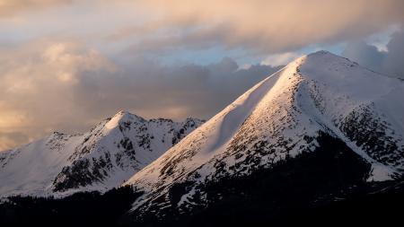 Mountain With Snow Under Cloudy Skies