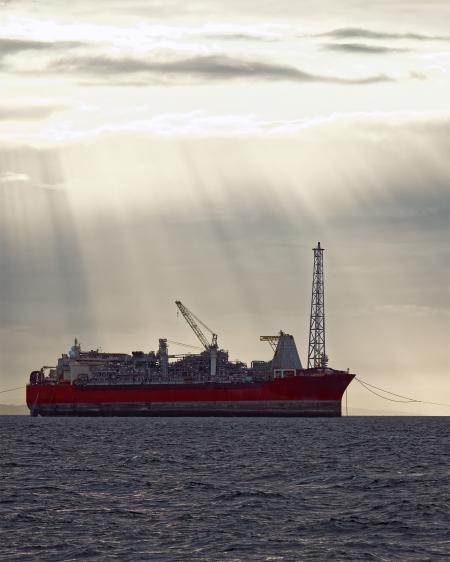 Oil and gas FPSO at sunset