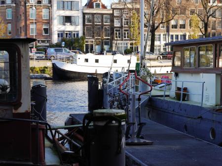 Old houseboats in the canal water of Amsterdam city