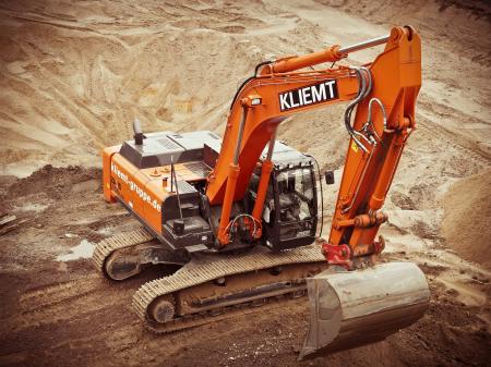 Orange Kliemt Excavator on Brown Soil