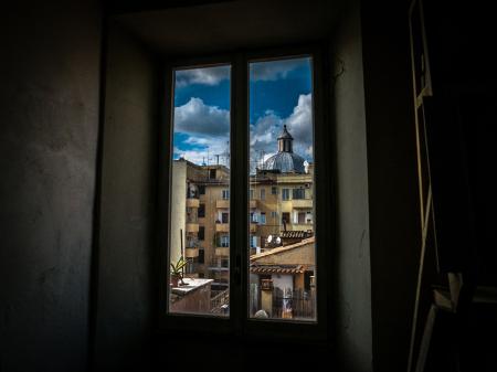 Painting of Window With View of Brown Buildings