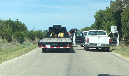 Parked, hogging the county road for no apparent reason.