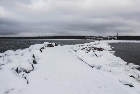 Pathway Between Body of Water Filled With Snow