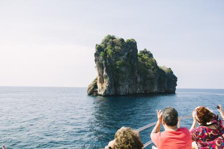 People on Rock by Sea