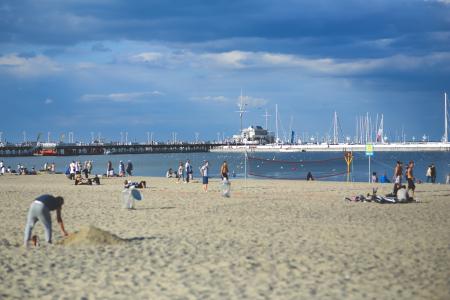 People on the beach. Pier & marina