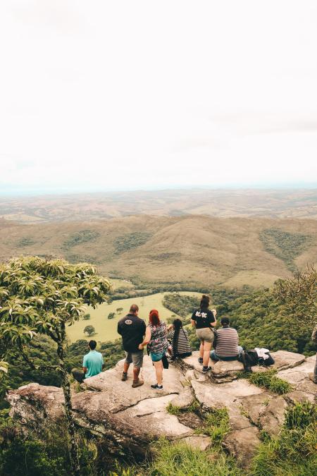 People Sitting and Standing on the Edge If Cliff