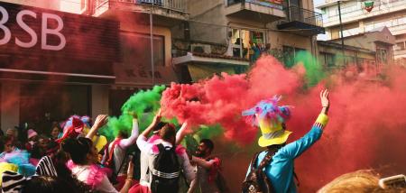 People Spraying Assorted Color Of Smoke