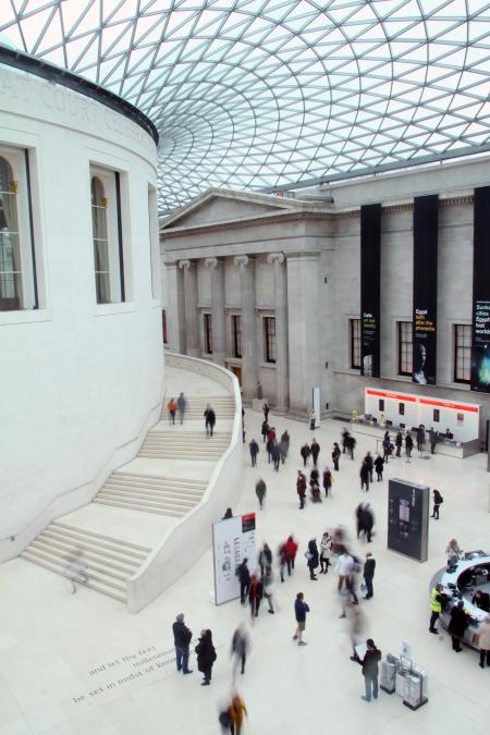 People Waling Inside White Concrete Building