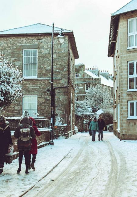 People Walking on Snow Covered Street