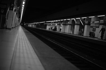 People Walking on Train Station Greyscale Photography