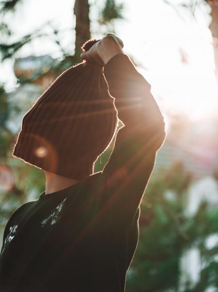 Person Covering Its Face With Knitted Hat