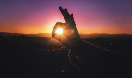 Person Doing Ok Hand Sign during Sunset