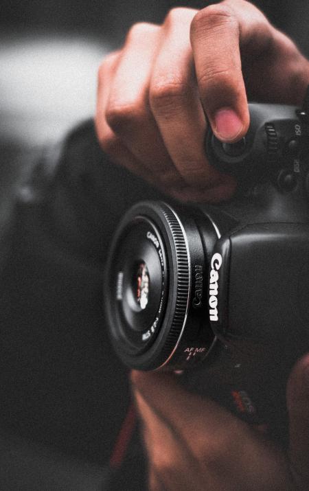 Person Holding Black Canon Dslr Camera Shallow Focus Photography