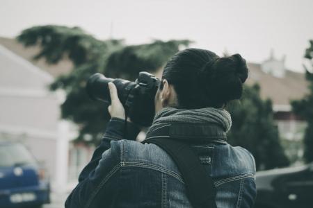 Person Holding Black Dslr Camera Wearing Blue Denim Jacket