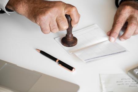 Person Holding Brown Stamp